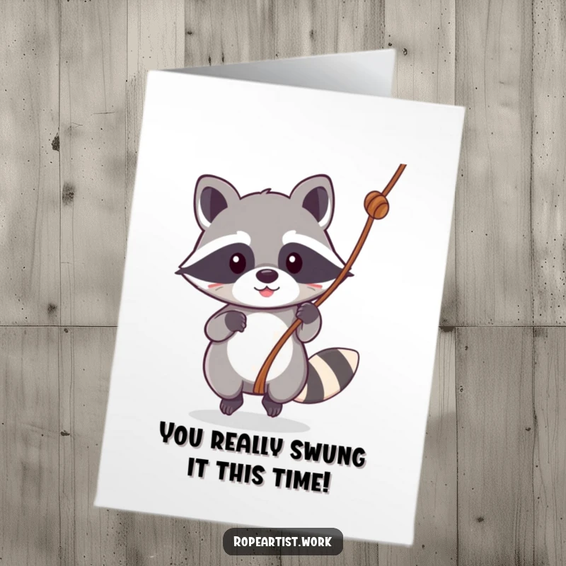 Funny free printable congratulations card: Cute kawaii raccoon swinging on a rope, celebrating success with pure delight.